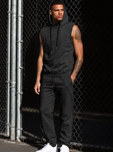 Men's dark grey sleeveless hoodie set shown in a street-style industrial setting