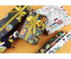 Detailed view of cartoon space-themed gift wrapping paper with astronauts and spaceships