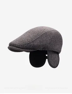 Detail of grey wool beret cap with earflaps and warm black fleece lining for men