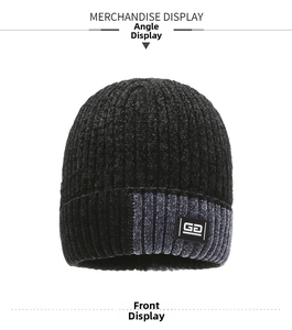 Front view of black cuffed knit beanie showing thick vertical ribbed texture and logo