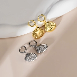 Minimalist shell-shaped earrings in gold and silver finish with polished metal textures