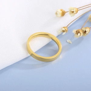 Macro shot of 3mm gold-plated flat polished stainless steel ring on elegant background