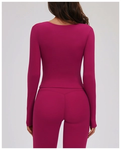Detail view of the back seams and berry pink fabric of this tight fit yoga set
