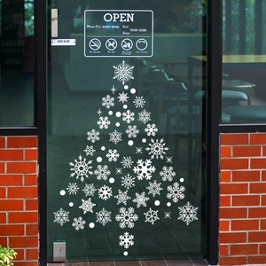 Christmas snowflake tree window sticker displayed on a glass shop door with white patterns