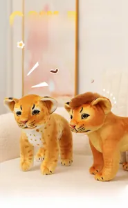 Detail of plush lion and leopard cub toys showing soft fur texture on a beige sofa