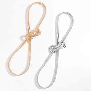 Detailed view of elastic spring waist belts in gold and silver with rhinestone buckles
