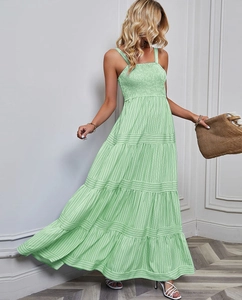 Detail of mint green tiered maxi dress with ruched bodice and thin spaghetti straps