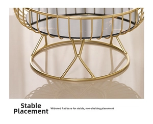 Detail of gold metal fruit tray with marble base and stable reinforced support stand