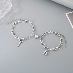 Detailed macro view of magnetic heart charm with key and lock on stainless steel chains