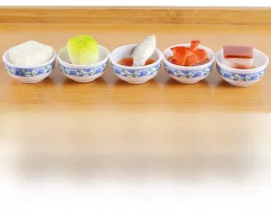 Detailed macro view of five miniature resin food models in blue and white porcelain bowls