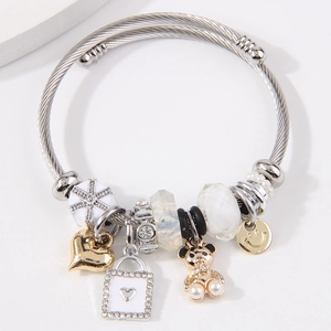 Adjustable stainless steel twisted bracelet with gold heart and crystal bear charms