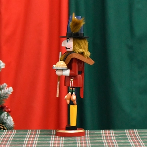 Wooden Nutcracker soldier decoration with red uniform and yellow boots on a festive backdrop