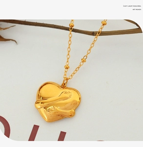 Detailed close-up of 18K gold-plated heart pendant necklace with unique hug relief pattern