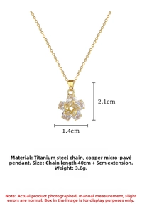 Macro shot of gold floral necklace pendant with zirconia and size measurements