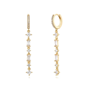Detail of long gold earrings with dangling cubic zirconia stones on white background