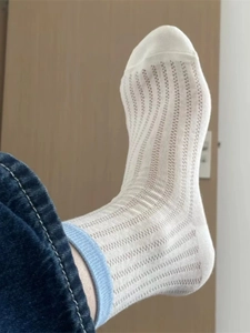 Detail of white cotton knit mid-calf sock featuring a light blue ribbed cuff design