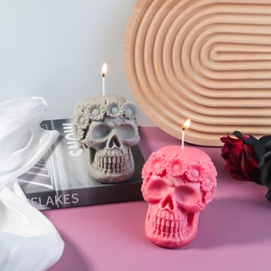 Detailed skull candle molds with floral wreath carving in gray and pink finishes
