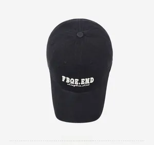Top view of black cotton baseball cap with white FBQE.END embroidery on the crown