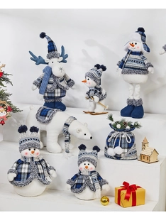 Blue and white plaid Christmas figurines including snowmen and reindeer on white steps