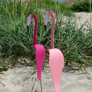 Detail of pink swirl bird garden stakes made of metal for outdoor patio beach decoration