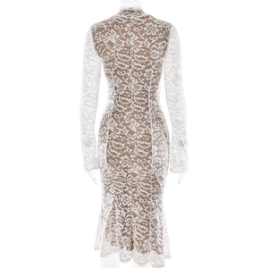 Detail view showing the back of a white lace bodycon dress with a fishtail hemline