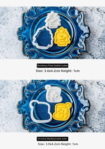 Detailed size view of Christmas tree and sock cookie molds in a blue ceramic plate