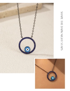 Detailed close-up of S925 silver necklace with blue turquoise evil eye pendant on model