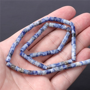 Natural blue spotted stone square beads necklace held in hand for jewelry making