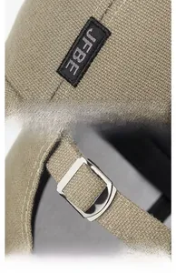 Detailed view of the embroidered JFBE logo and the adjustable silver metal buckle on the tan cap