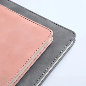 Premium A5 PU leather notebooks in pink and grey with precision stitching and rounded corners