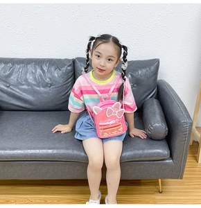 Pink sequin backpack with cute cat ears and transparent window worn by a young girl