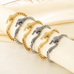 Golden and silver snake head bracelets on display with stainless steel chain