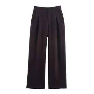 Detailed view of high-waisted dark brown wide-leg linen trousers with front pleats