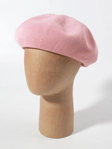 Detailed close-up of pink breathable knitted linen beret on wooden head model
