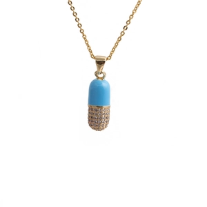 Detail of blue and gold pill-shaped capsule pendant with micro-pave cubic zirconia