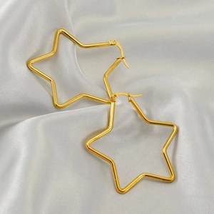 Minimalist 18k gold plated stainless steel hollow star earrings on white silk