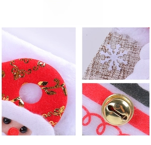Detail of plush Christmas stockings showing golden embroidery, burlap texture and bells