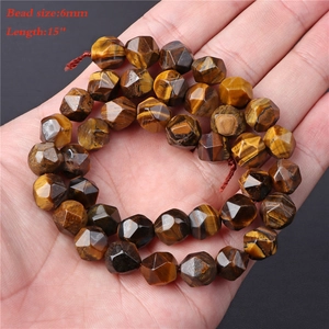 Macro shot of 6mm faceted yellow tiger eye stone beads on a 15-inch string strand