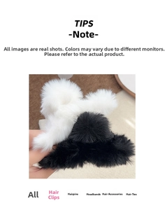 Detail of plush faux rabbit fur claw clips in black and white for thick hair styling