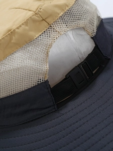 Outdoor sun hat featuring breathable mesh panels and adjustable back strap with plastic buckle