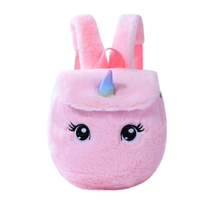 Close-up of pink unicorn plush backpack with rainbow horn and embroidered eyelashes