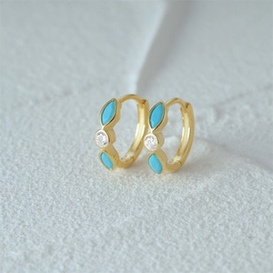 Detail of gold-plated hoop earrings featuring marquise turquoise and white zircon stones