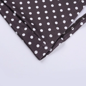 Close-up of black fabric with white polka dots showing double-needle hem and stitching