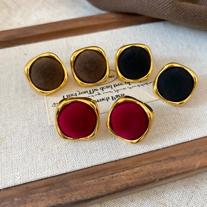 Detail of vintage square velvet stud earrings in burgundy, black and coffee gold tones