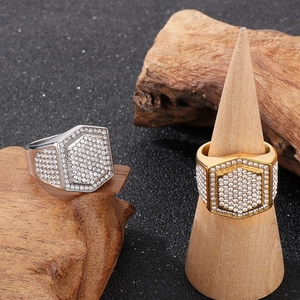 Detail of luxury hip hop rings in gold and silver finish with pave-set crystal stones