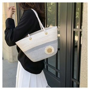 Floral hand-woven cotton shoulder tote bag with daisy detail shown on a female model