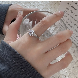 Detailed close-up of zircon ring with twisted band and pavé setting on a silver ring
