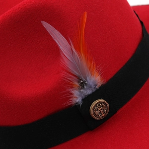 Red wool felt fedora hat featuring wide brim with black ribbon and vintage feather detail