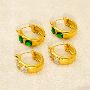 Detailed view of chunky 18K gold plated hoop earrings set with green and white zircon