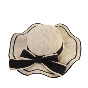 Beige wide brim straw sun hat with black bow and wavy edge for summer beach vacation